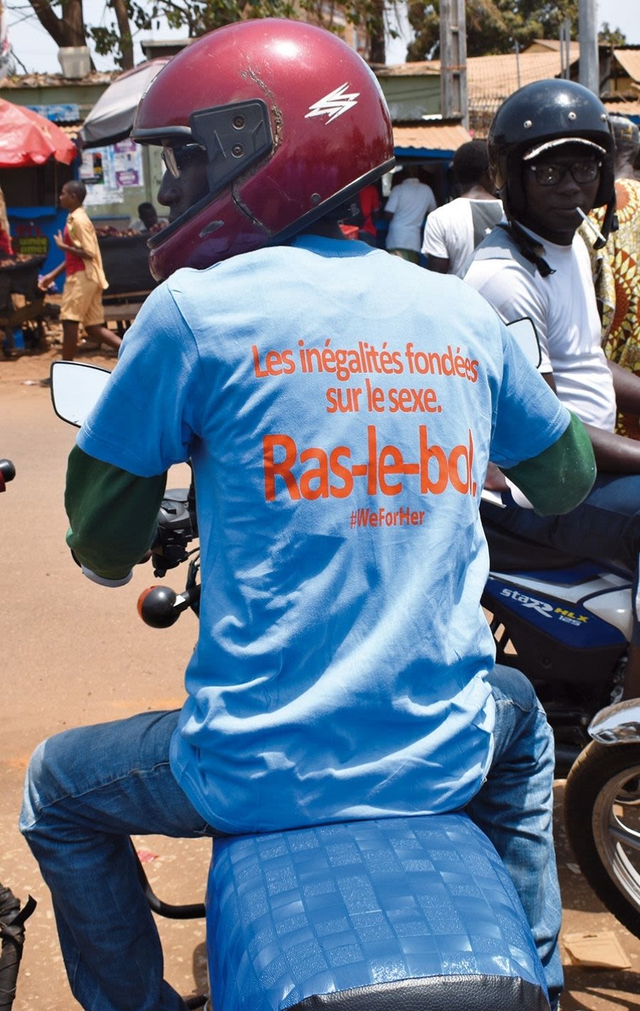 Biker showing his back with a sign saying “Gender inequality. Enough is enough”