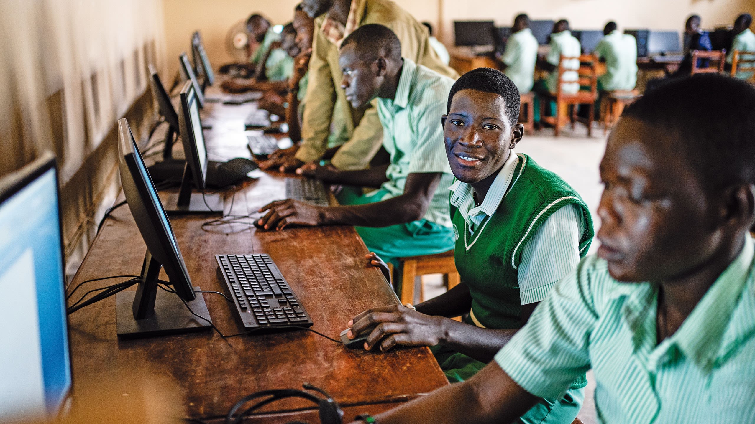 Man sitting at a computer and looking at the camera